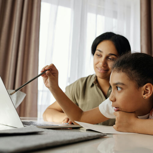 Stock image of a family using a laptop together.