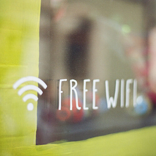 Stock image of a Free WiFi sign in a store window.