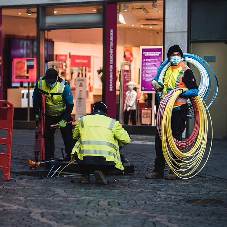Stock image of workers installing infrastructure cables.