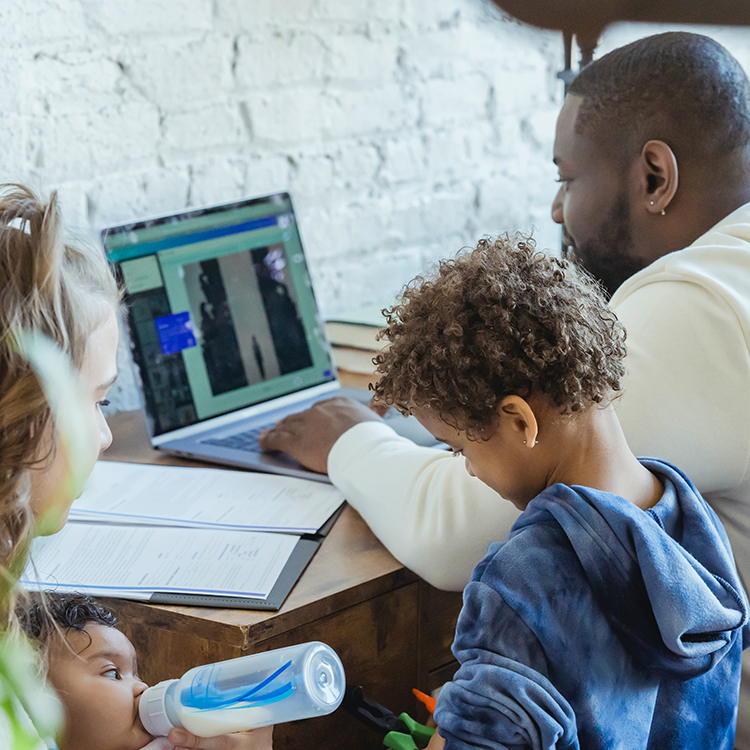 Stock image of a family using a laptop together.